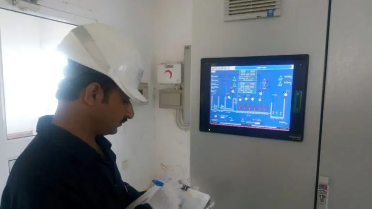 photo of an operator monitor a sewage treatment plant