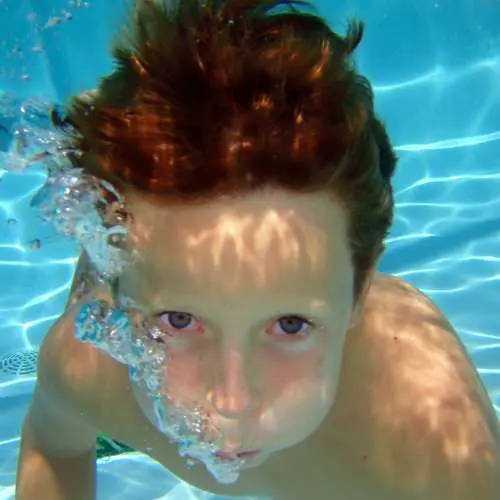 child swim in pool