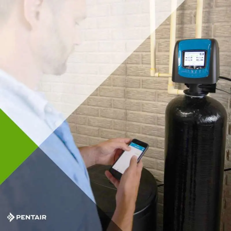 photo shows professional adjusting the water softener connected through Wi-Fi