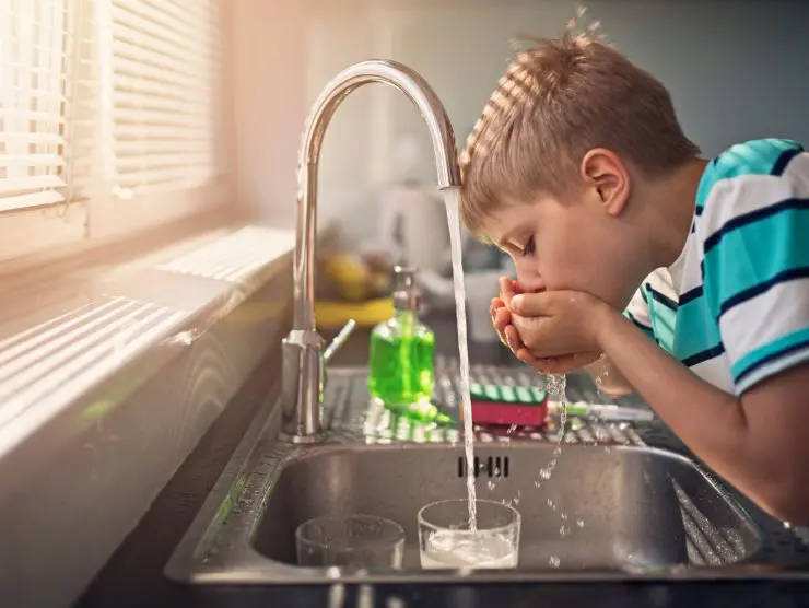 Boy drink Water form tap